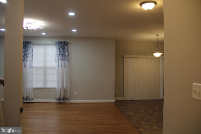 interior space featuring recessed lighting, dark wood-style flooring, and baseboards