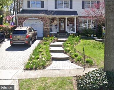 view of front of property featuring a garage and covered porch