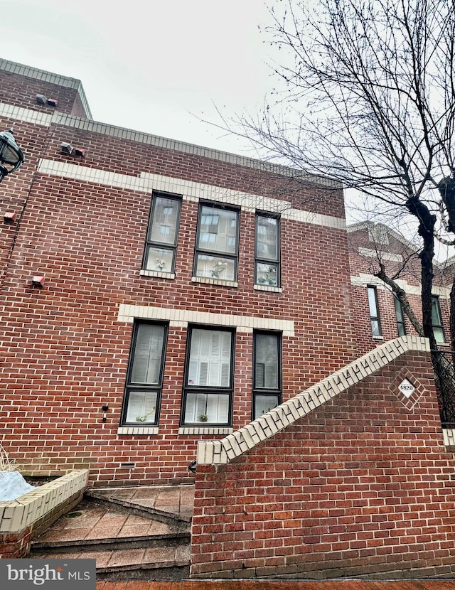 view of side of property with brick siding