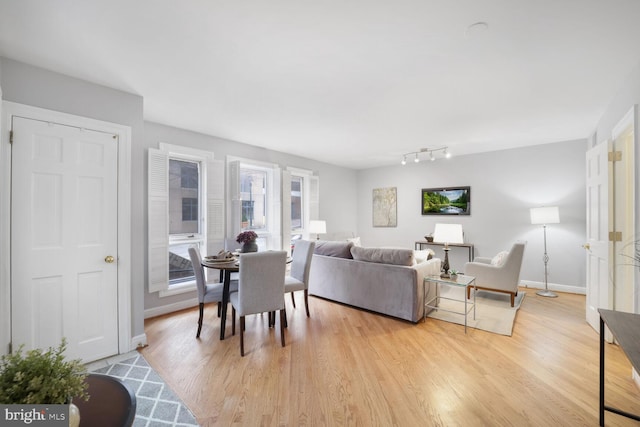 living room featuring baseboards and light wood-style floors