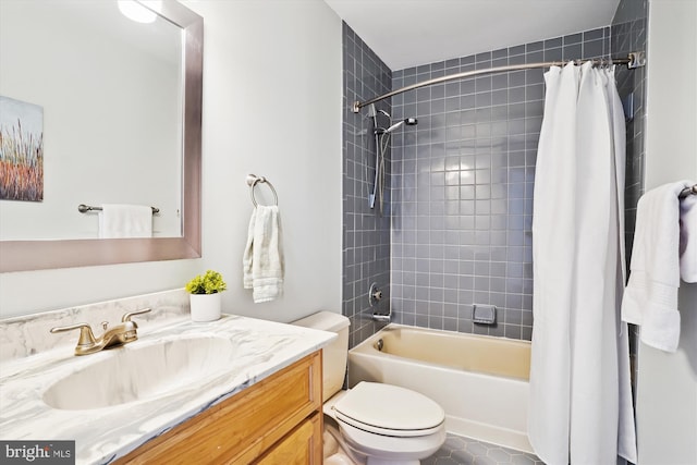 full bathroom featuring shower / tub combo with curtain, toilet, tile patterned floors, and vanity