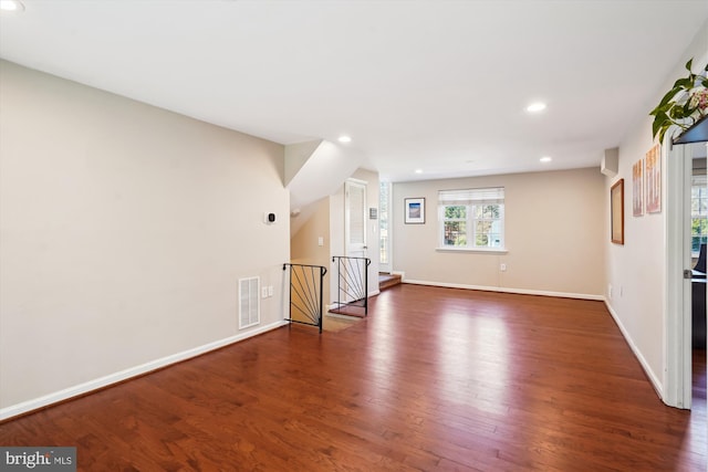 unfurnished living room with baseboards, visible vents, wood finished floors, and recessed lighting