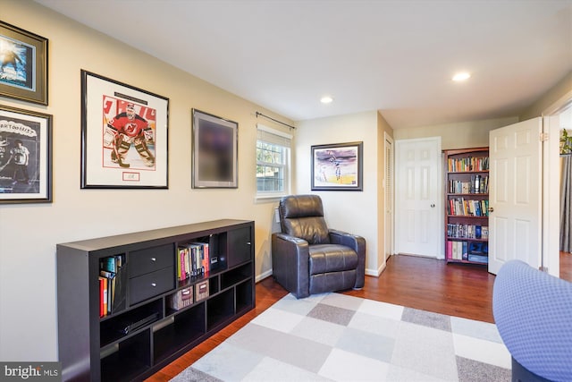 sitting room with recessed lighting, baseboards, and wood finished floors