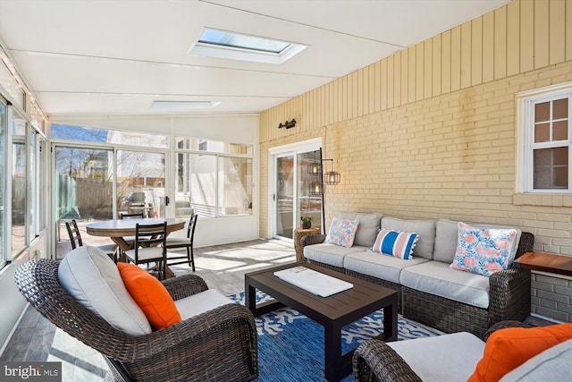 sunroom / solarium with lofted ceiling with skylight