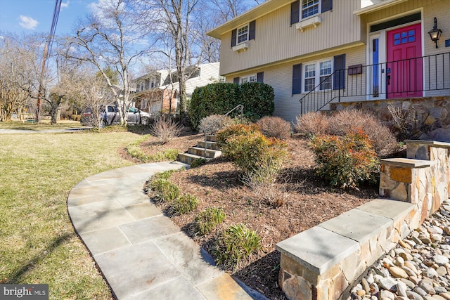 exterior space featuring a lawn and brick siding