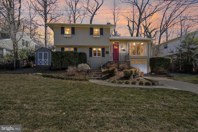 tri-level home with an outbuilding, brick siding, a storage unit, concrete driveway, and a front lawn