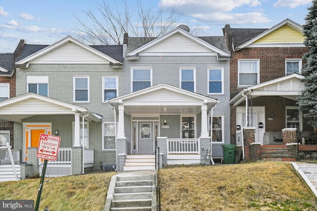 view of front of house with covered porch and a front yard