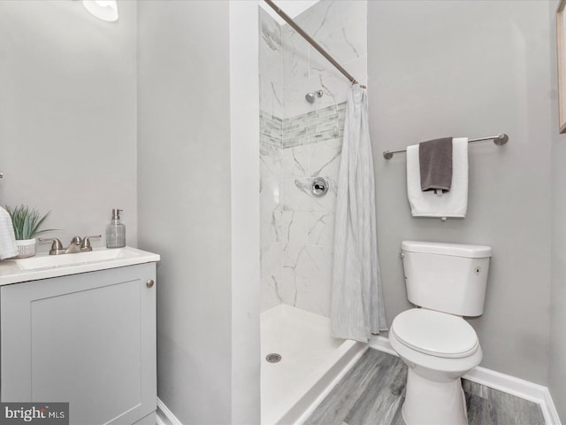 bathroom with a shower with curtain, vanity, toilet, and hardwood / wood-style floors