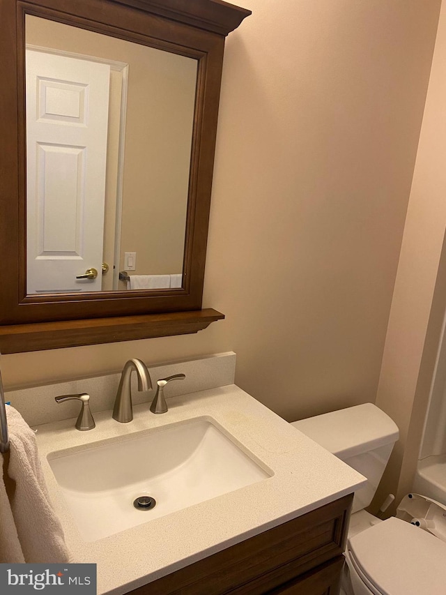 bathroom featuring vanity and toilet