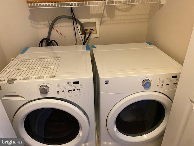 clothes washing area featuring washer and clothes dryer