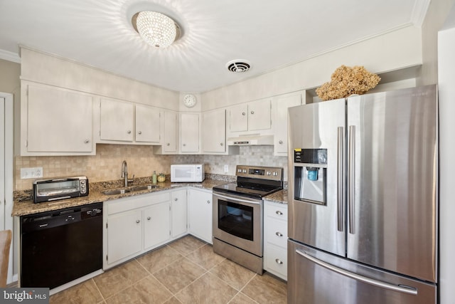 kitchen with stainless steel appliances, light stone countertops, decorative backsplash, sink, and white cabinetry