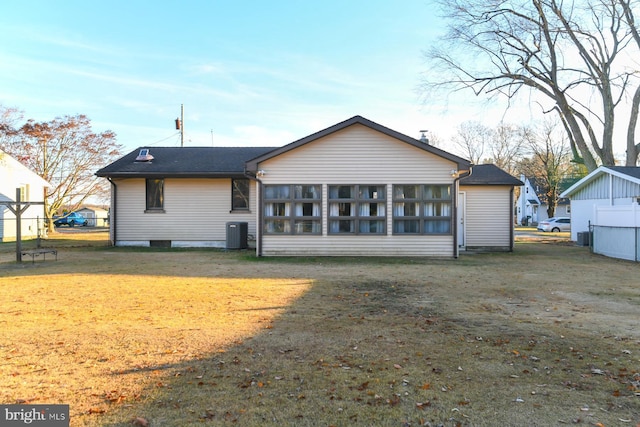 rear view of house featuring a lawn