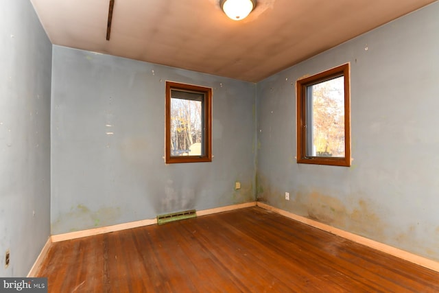 spare room with dark hardwood / wood-style flooring