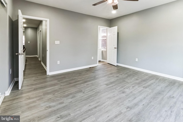 unfurnished bedroom with a ceiling fan, baseboards, and wood finished floors