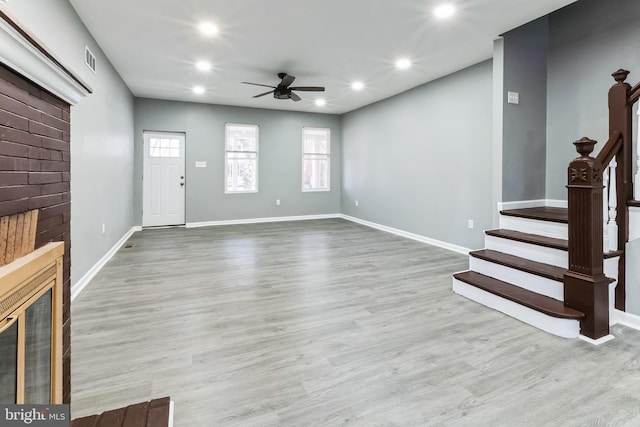 unfurnished living room with recessed lighting, visible vents, a ceiling fan, wood finished floors, and stairs