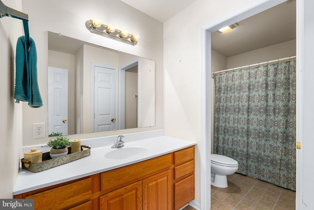 bathroom with tile patterned floors, toilet, vanity, and walk in shower