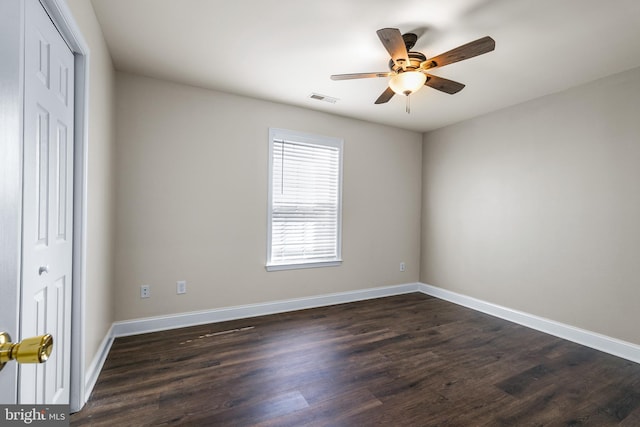 unfurnished bedroom featuring ceiling fan, dark wood-type flooring, and a closet