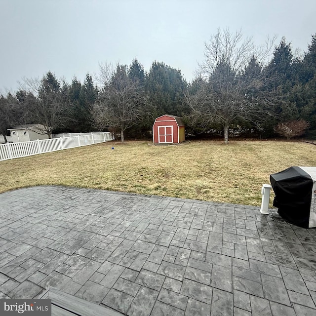 view of patio with a storage unit and a grill