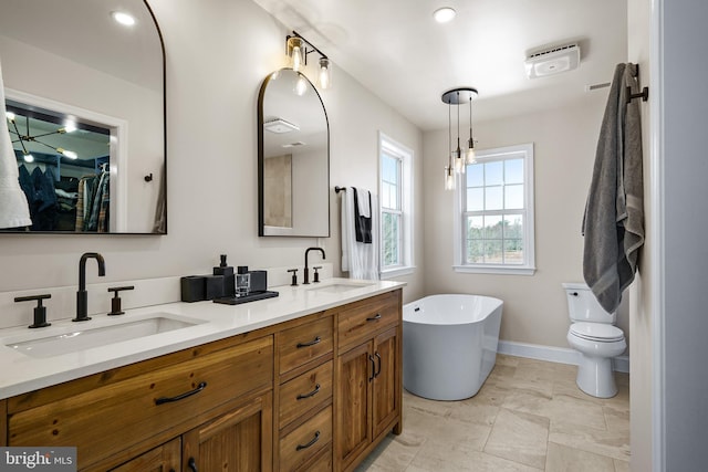 bathroom featuring toilet, vanity, and a bathtub