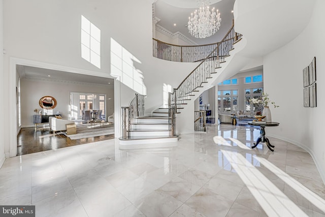 foyer entrance featuring a high ceiling, a chandelier, and french doors