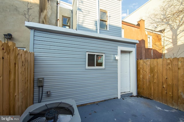 rear view of property featuring cooling unit