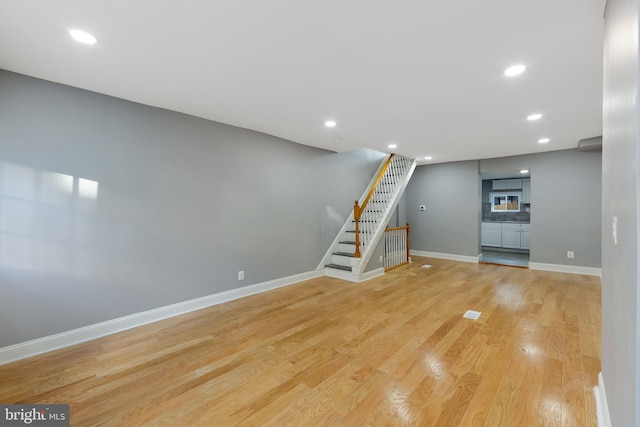 basement featuring light hardwood / wood-style flooring