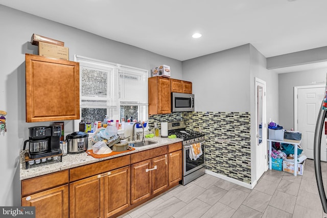 15 White St, Paterson, NJ 07522 - kitchen featuring light stone counters, appliances with stainless steel finishes, sink, and tasteful backsplash