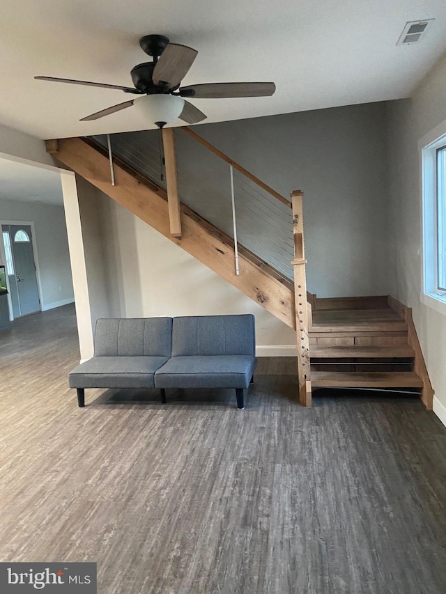 interior space with baseboards, stairs, visible vents, and dark wood-type flooring