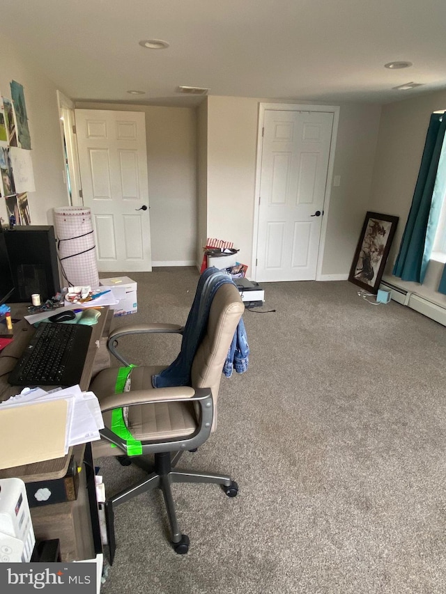 carpeted office space featuring visible vents and baseboards