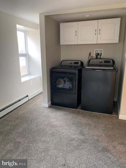 clothes washing area featuring carpet floors, independent washer and dryer, cabinet space, and baseboards