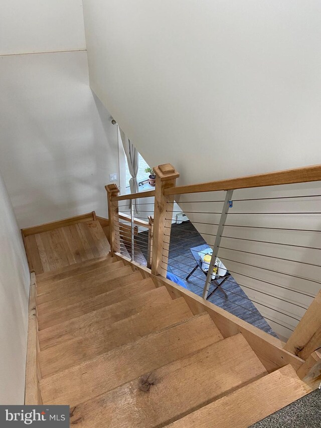 stairway with wood finished floors