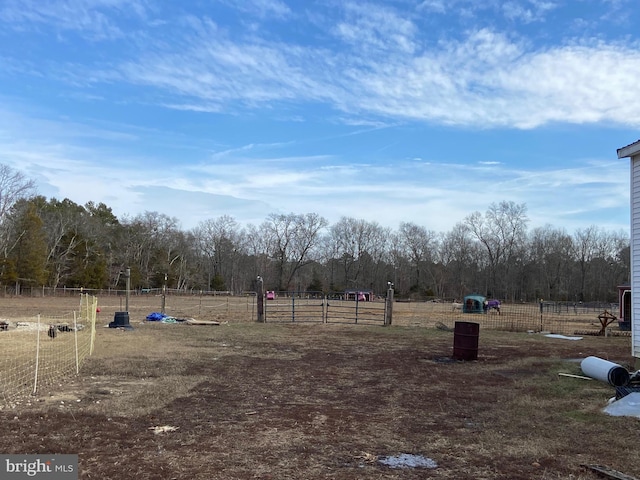 view of yard featuring fence and a rural view