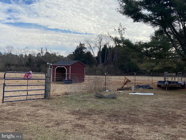 view of yard with an outbuilding, fence, and an outdoor structure