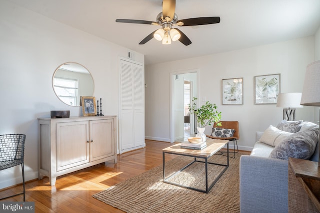 living room with ceiling fan and light hardwood / wood-style flooring