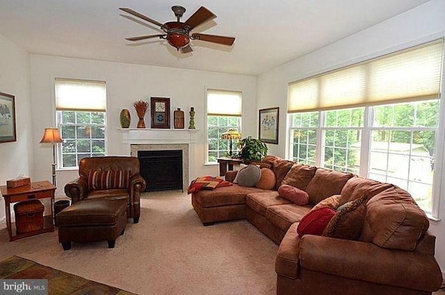 carpeted living room with ceiling fan
