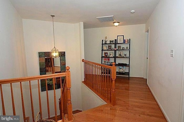 corridor with wood-type flooring