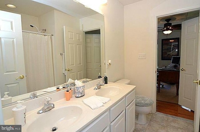 bathroom with toilet, ceiling fan, a shower with shower curtain, and vanity