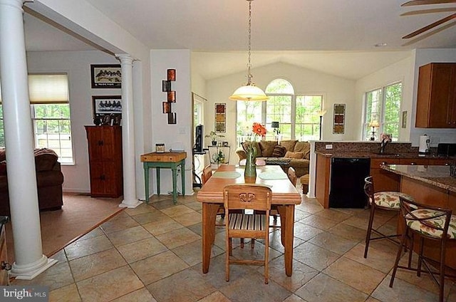 dining room with plenty of natural light, sink, ornate columns, and lofted ceiling