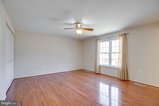 empty room with light hardwood / wood-style floors and ceiling fan