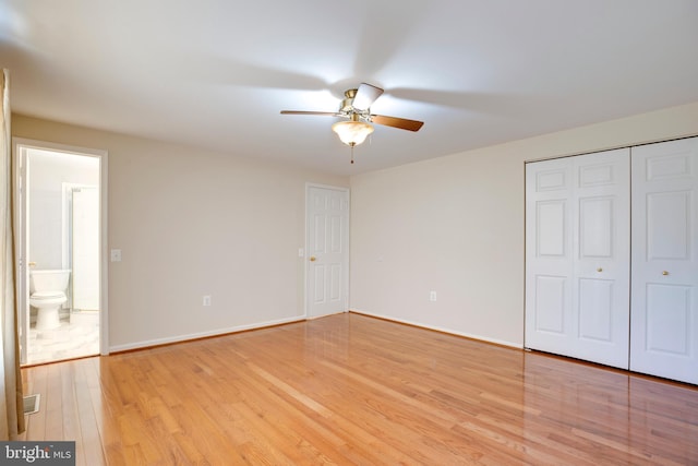 unfurnished bedroom featuring light wood-type flooring, a closet, and ceiling fan