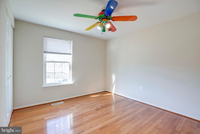 spare room with light wood-type flooring and ceiling fan