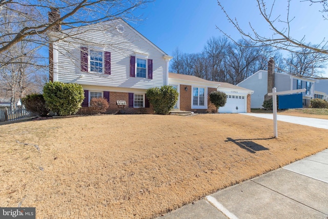 tri-level home featuring a front yard and a garage