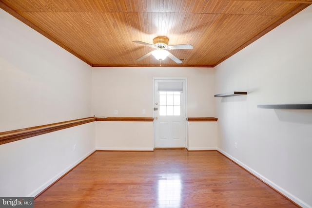 unfurnished room featuring ceiling fan, light hardwood / wood-style flooring, crown molding, and wood ceiling