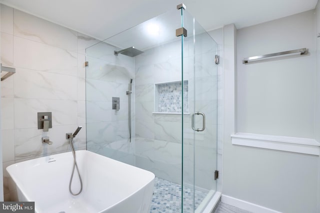 bathroom with separate shower and tub