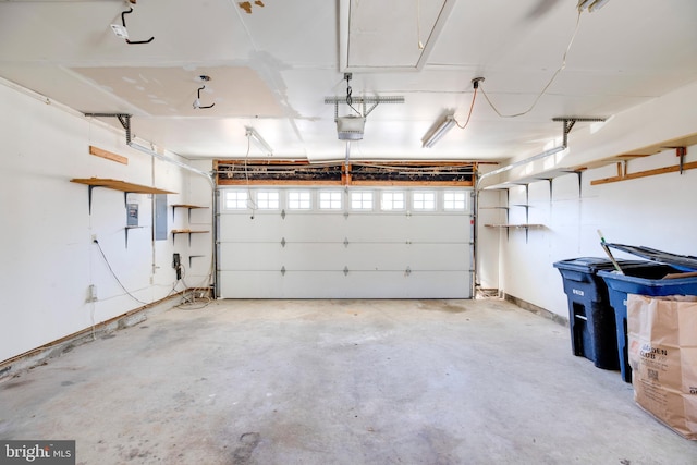 garage with electric panel and a garage door opener