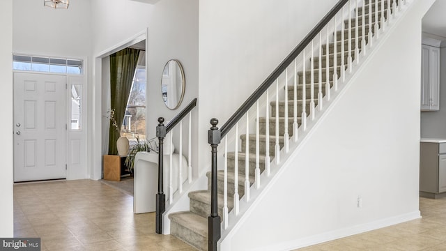 foyer entrance with a towering ceiling