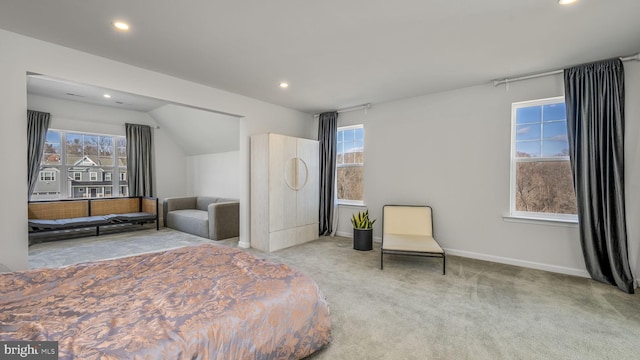 bedroom featuring multiple windows, light carpet, and vaulted ceiling