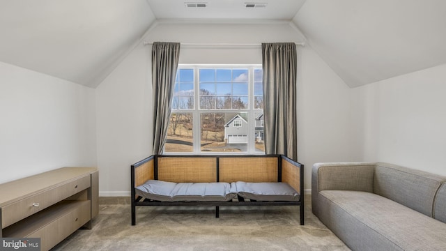 sitting room with carpet floors and lofted ceiling