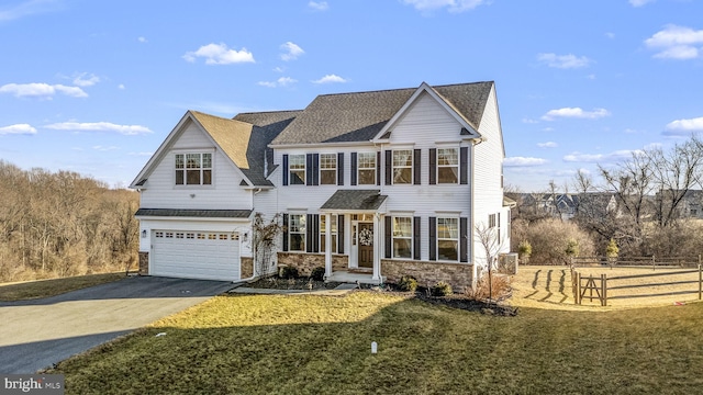 view of front of house with a garage and a front yard