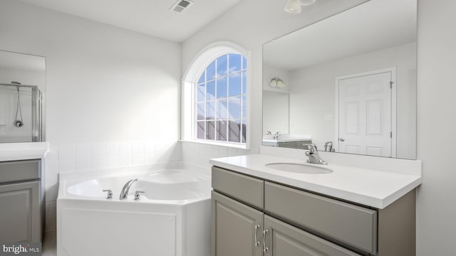 bathroom with plus walk in shower and vanity